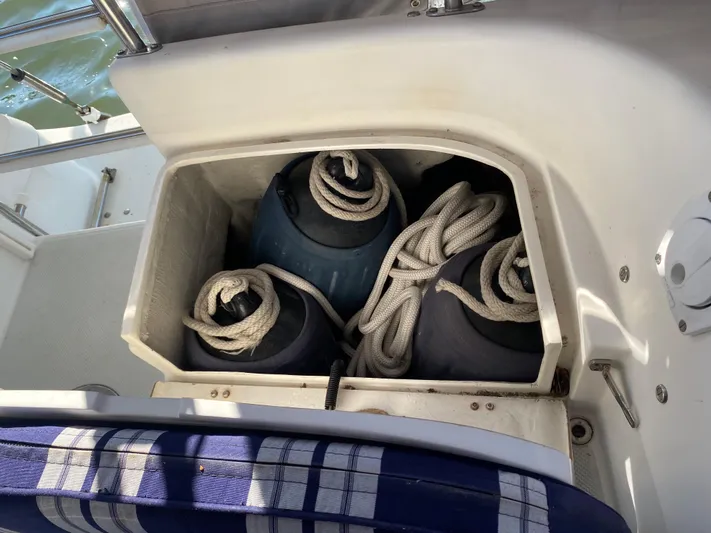  Yacht Photos Pics Storage compartment on a 2001 Catalina 42 MkII sailboat with fenders and ropes.