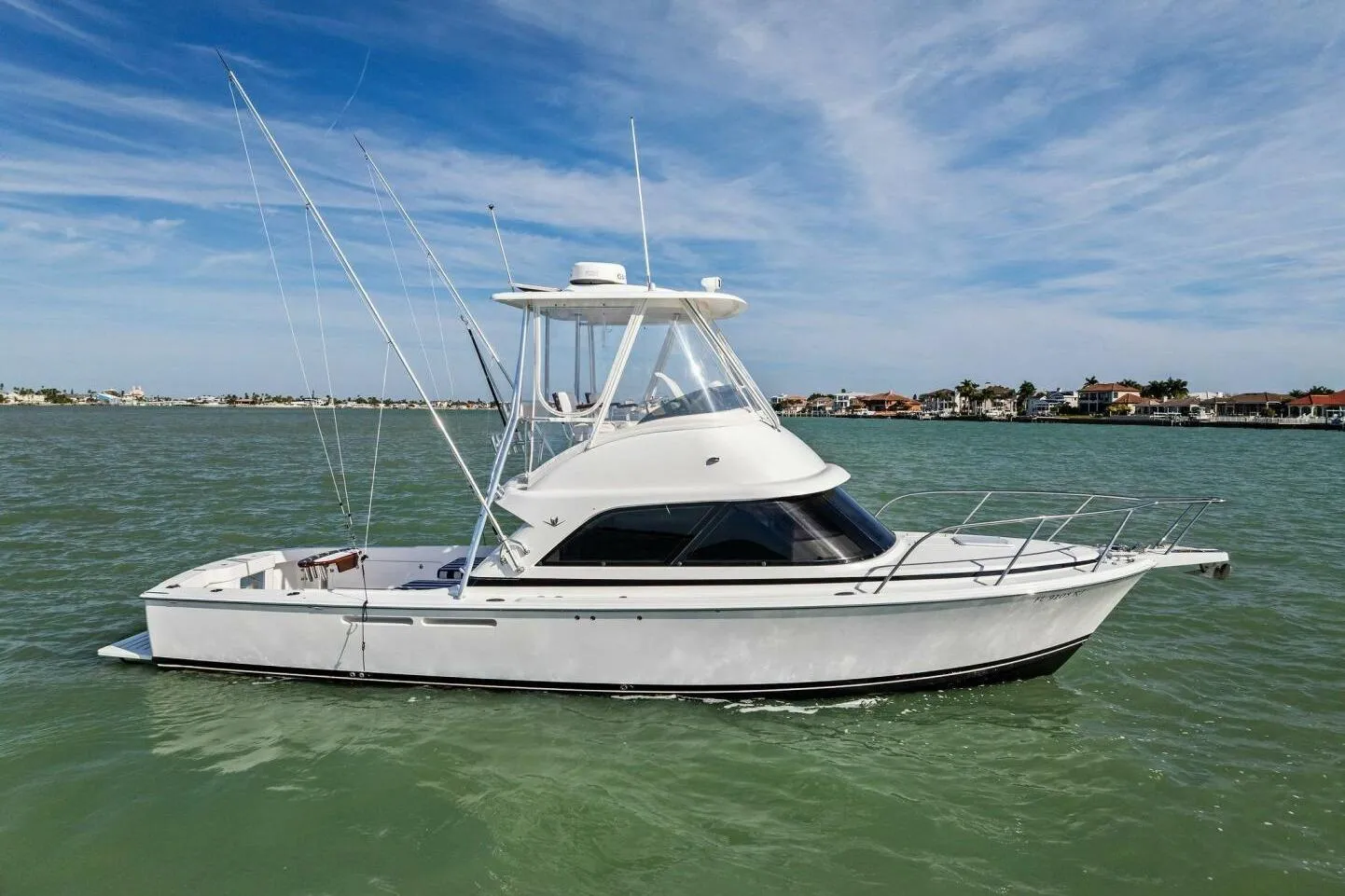 2017 Bertram 35 Flybridge boat on calm water under a clear sky.
