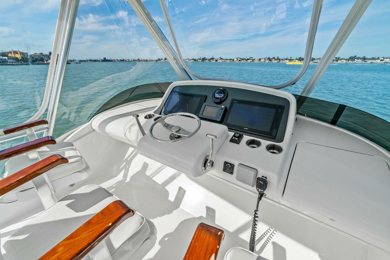 2017 Bertram 35 Flybridge helm with modern controls and ocean view.