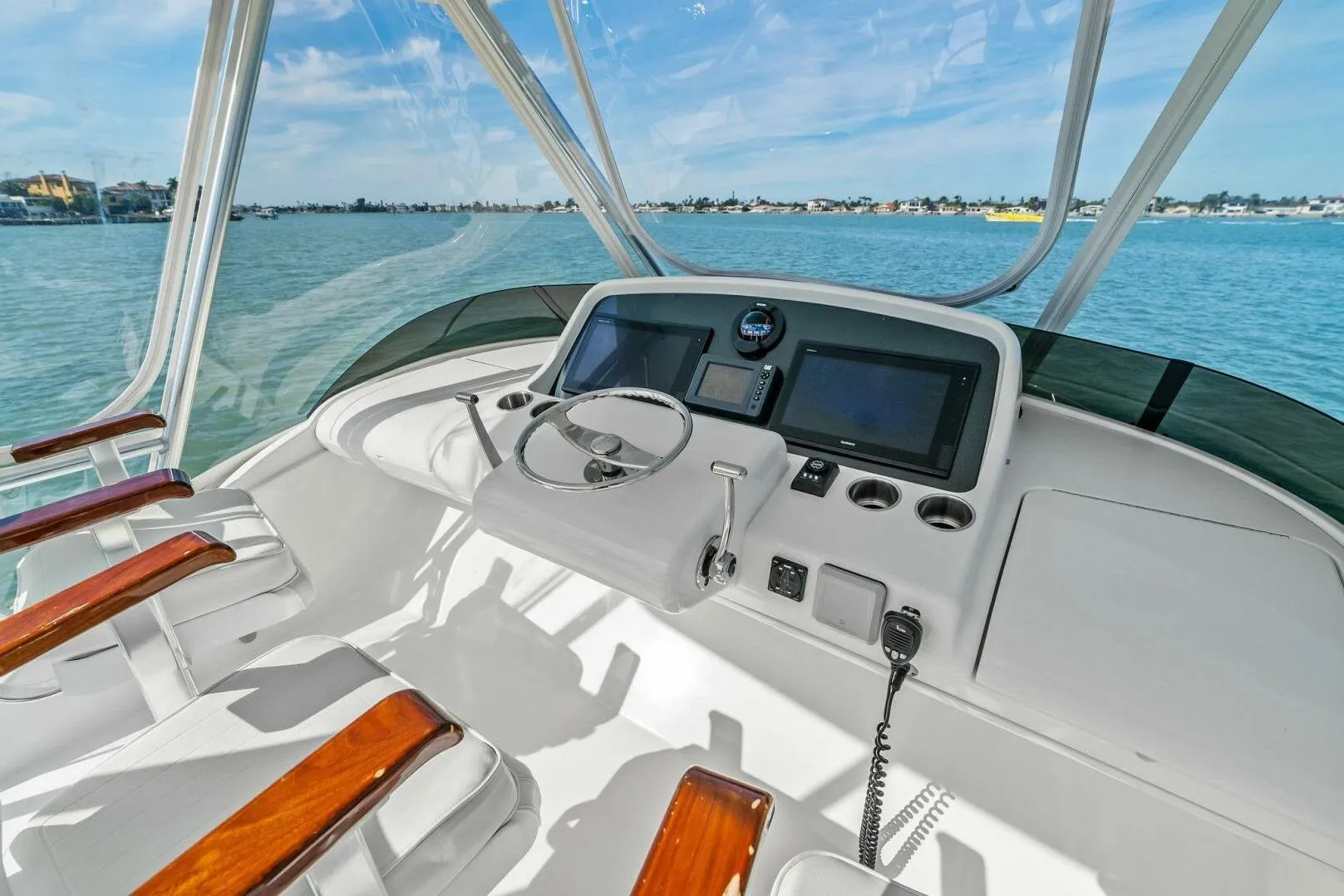 2017 Bertram 35 Flybridge helm with modern controls and ocean view.