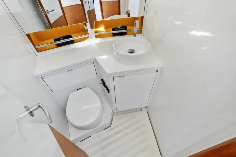 Still Dancing Yacht Photos Pics Modern bathroom in 2017 Bertram 35 Flybridge yacht with sleek fixtures and white cabinetry.