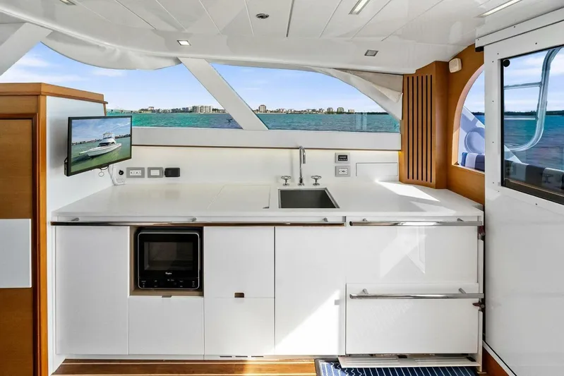 Still Dancing Yacht Photos Pics Luxurious 2017 Bertram 35 Flybridge yacht interior with modern kitchen and ocean view.