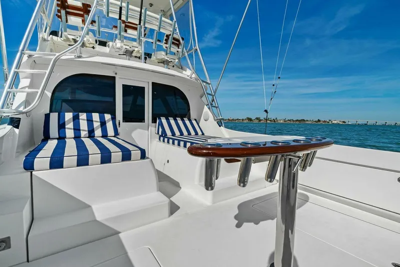 Still Dancing Yacht Photos Pics 2017 Bertram 35 Flybridge yacht with striped seating, ocean view, and fishing rod holders.