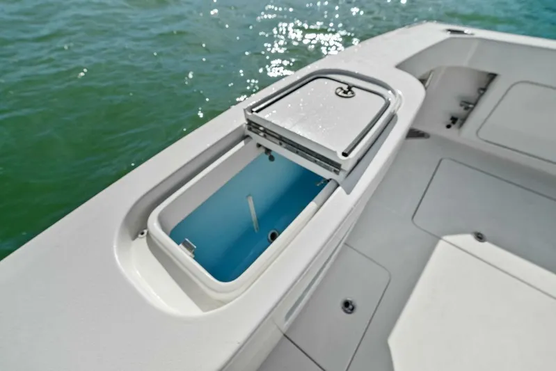 Still Dancing Yacht Photos Pics Bertram 35 Flybridge 2017 boat deck with open storage compartment by the water.