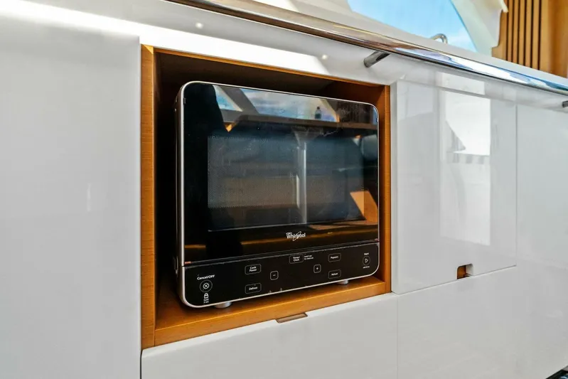Still Dancing Yacht Photos Pics Built-in microwave on 2017 Bertram 35 Flybridge yacht, featuring sleek white cabinetry.