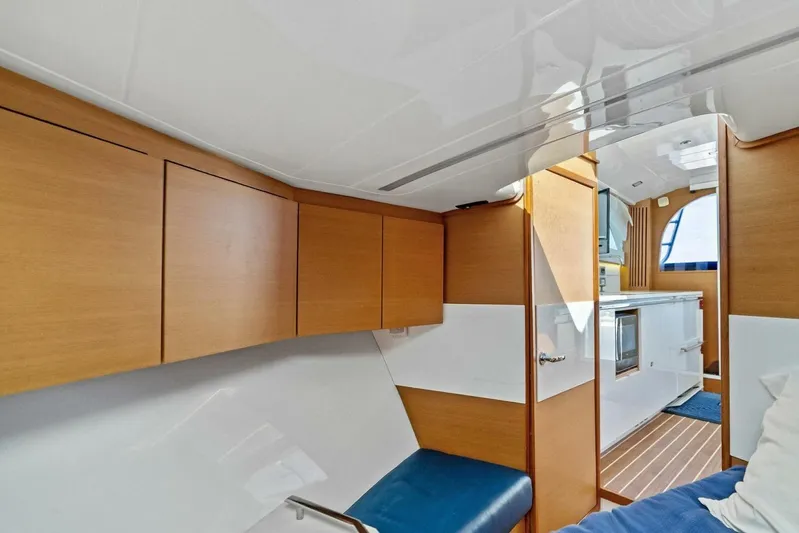 Still Dancing Yacht Photos Pics Interior of 2017 Bertram 35 Flybridge yacht with modern wood cabinetry and seating.