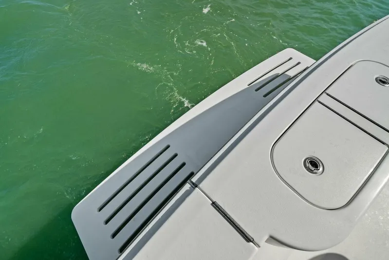 Still Dancing Yacht Photos Pics 2017 Bertram 35 Flybridge boat deck with swim platform on green water.