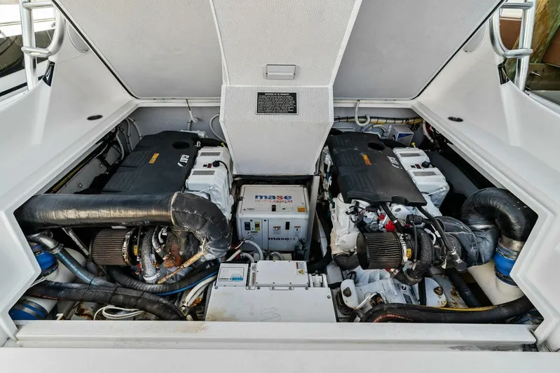 Still Dancing Yacht Photos Pics Engine compartment of a 2017 Bertram 35 Flybridge boat, showcasing dual engines and generator.
