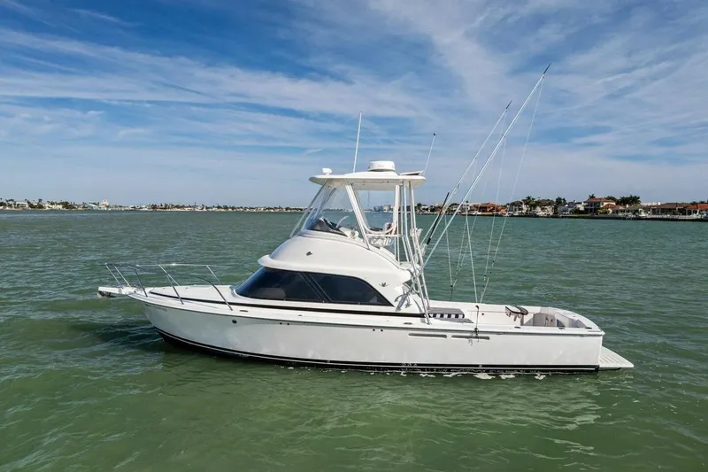 Still Dancing Yacht Photos Pics 2017 Bertram 35 Flybridge yacht on calm waters under a clear blue sky.