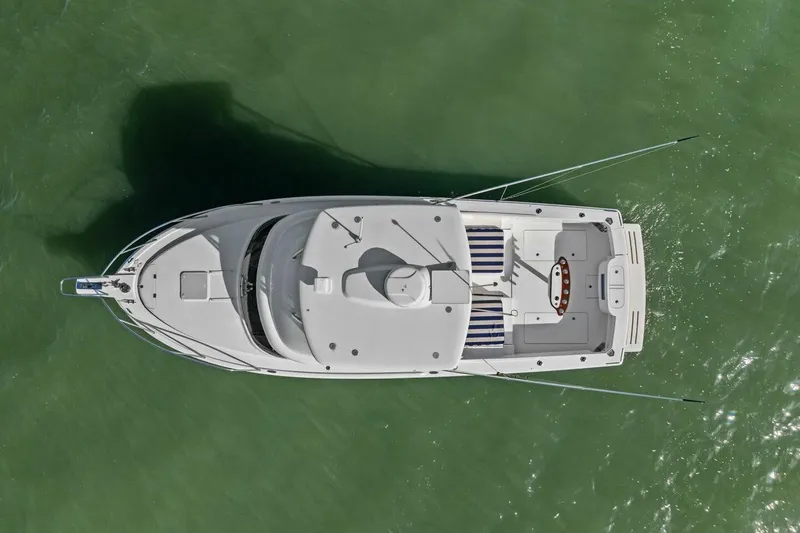 Still Dancing Yacht Photos Pics Top view of a 2017 Bertram 35 Flybridge boat on green water.