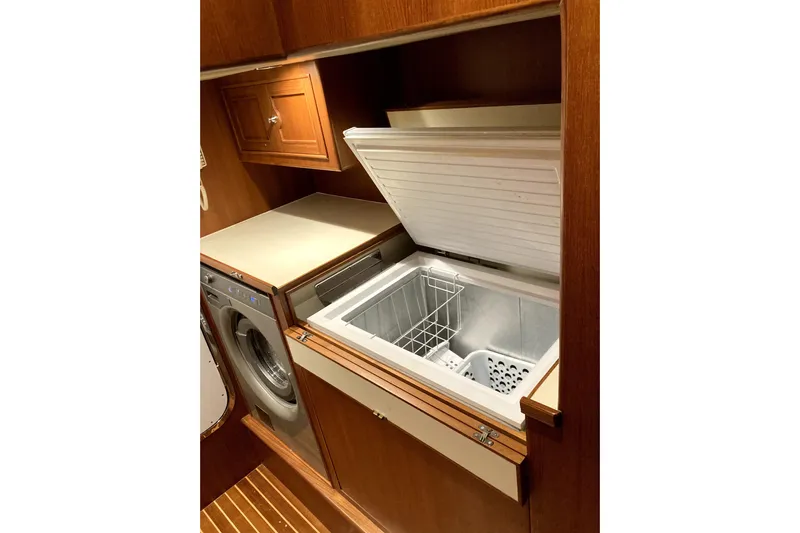Grace Yacht Photos Pics Laundry area with washer and open freezer in 2019 Marlow 49E yacht.