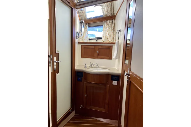 Grace Yacht Photos Pics Luxurious Marlow 49E 2019 yacht bathroom with wooden accents and modern fixtures.