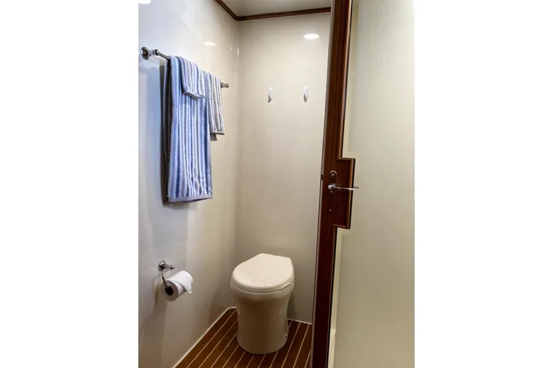 Grace Yacht Photos Pics Compact bathroom in 2019 Marlow 49E yacht with modern fixtures and wooden accents.