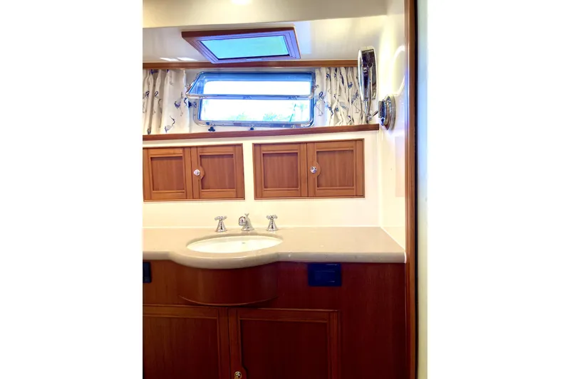 Grace Yacht Photos Pics Luxurious Marlow 49E 2019 yacht bathroom with wooden cabinets and modern fixtures.