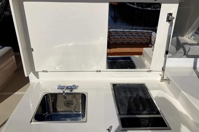 Grace Yacht Photos Pics Outdoor kitchen area on a 2019 Marlow 49E yacht with sink and grill.
