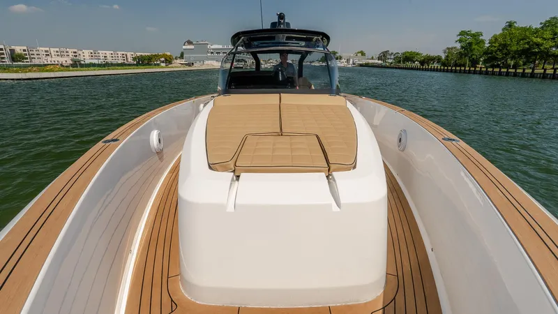  Yacht Photos Pics 2023 Pardo Yachts P38 luxury yacht with teak deck and sunbed, cruising on calm waters.