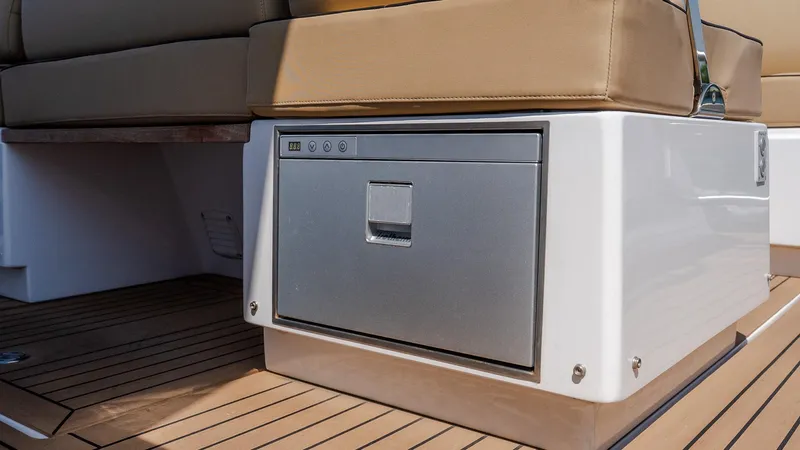  Yacht Photos Pics 2023 Pardo Yachts P38 interior with cushioned seating and integrated storage on teak flooring.