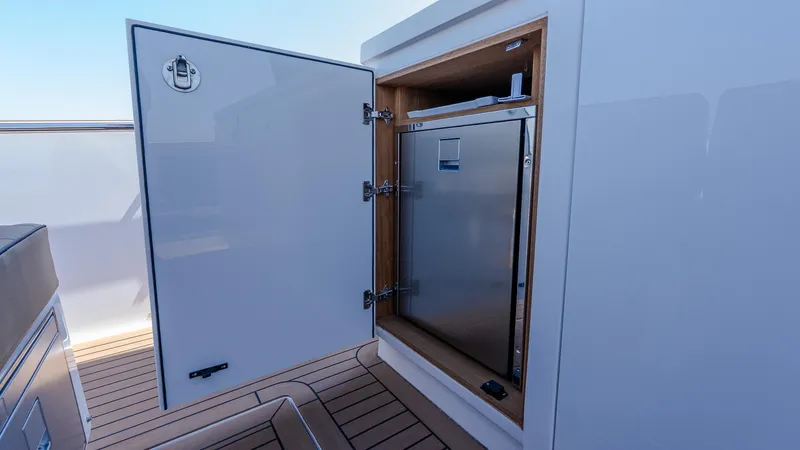  Yacht Photos Pics Open storage compartment on 2023 Pardo Yachts P38, featuring sleek design and wood accents.