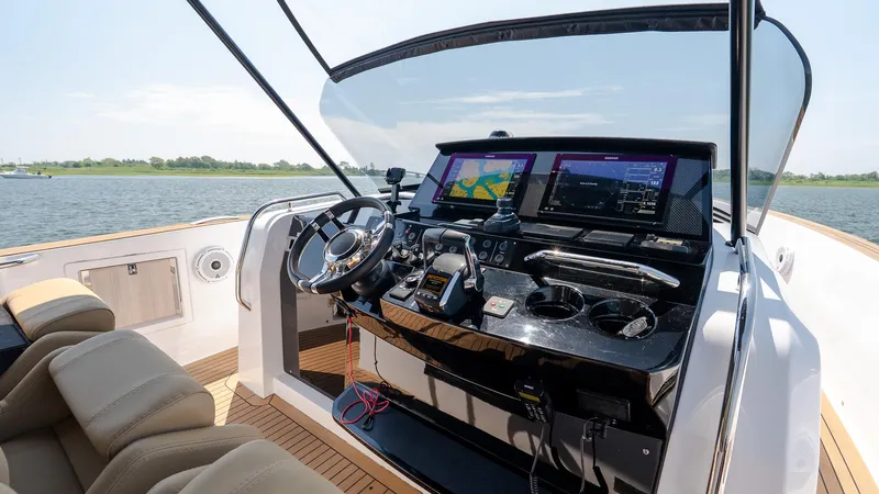  Yacht Photos Pics 2023 Pardo Yachts P38 helm with modern navigation screens and luxurious seating on open water.