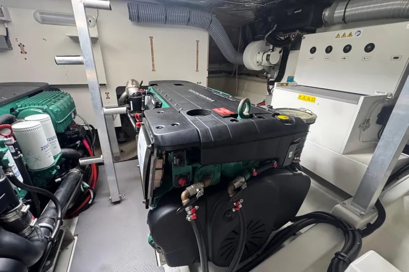 Serenity Yacht Photos Pics Engine room of 2023 Prestige 460S yacht with visible machinery and components.