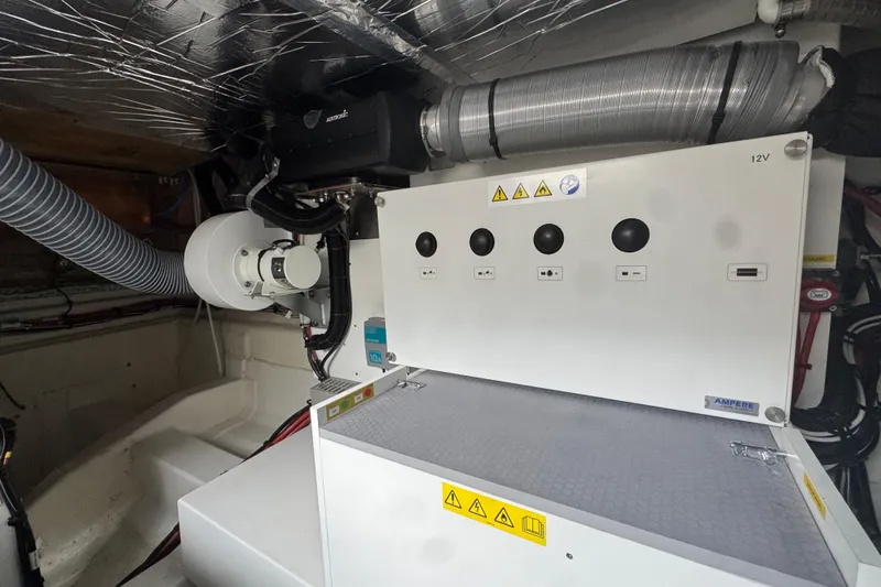 Serenity Yacht Photos Pics Engine room of 2023 Prestige 460S yacht with electrical panel and ventilation system.