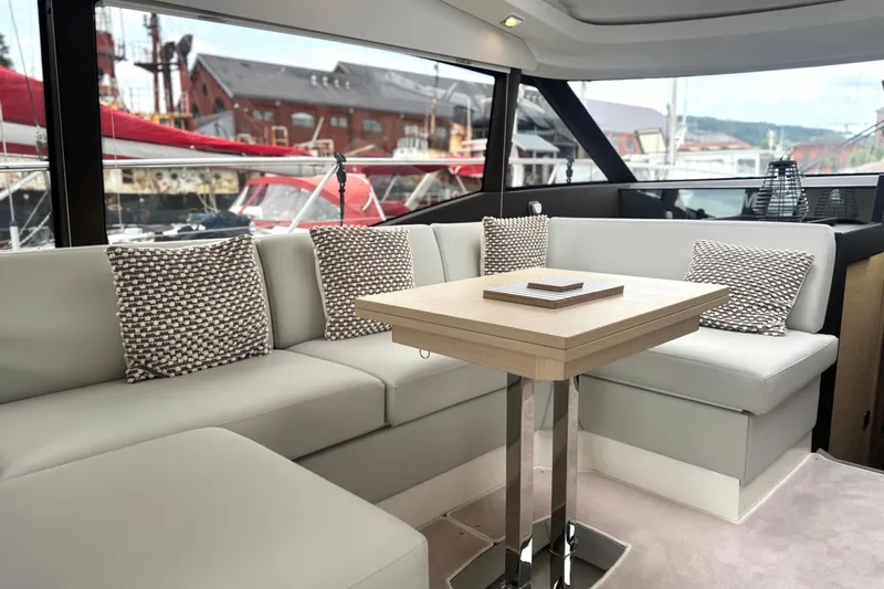 Serenity Yacht Photos Pics Luxurious interior of 2023 Prestige 460S yacht with elegant seating and modern decor.