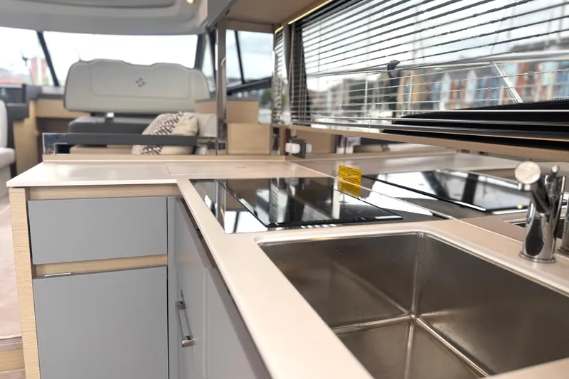 Serenity Yacht Photos Pics Modern kitchen interior of 2023 Prestige 460S yacht with sleek design and stainless steel sink.