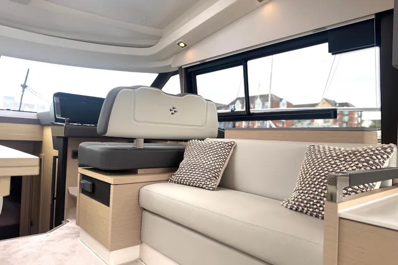Serenity Yacht Photos Pics Luxurious interior of 2023 Prestige 460S yacht with modern seating and stylish cushions.