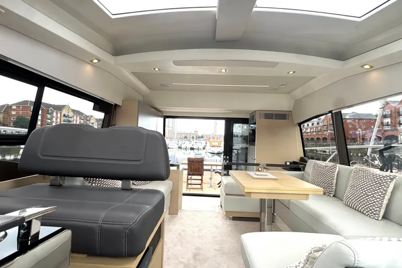 Serenity Yacht Photos Pics Luxurious interior of 2023 Prestige 460S yacht with modern seating and large windows.