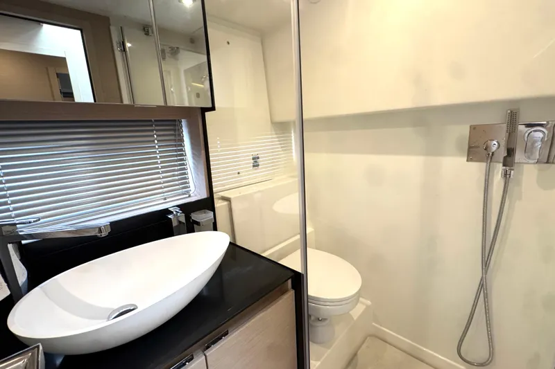Serenity Yacht Photos Pics Modern bathroom in 2023 Prestige 460S yacht with sleek sink and shower.