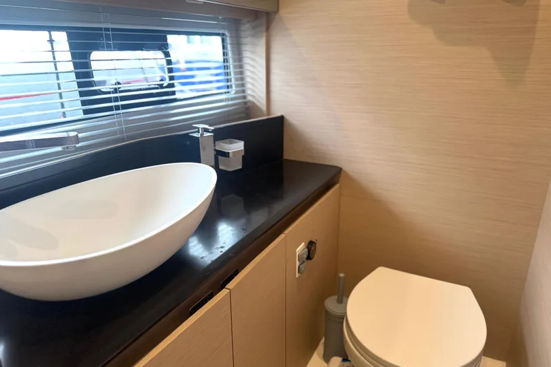 Serenity Yacht Photos Pics Modern bathroom in 2023 Prestige 460S yacht with sleek sink and toilet.