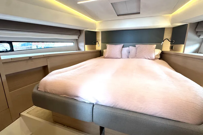Serenity Yacht Photos Pics Luxurious bedroom interior of 2023 Prestige 460S yacht with elegant bedding and ambient lighting.