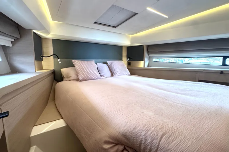 Serenity Yacht Photos Pics Luxurious bedroom interior of 2023 Prestige 460S yacht with modern design and soft lighting.