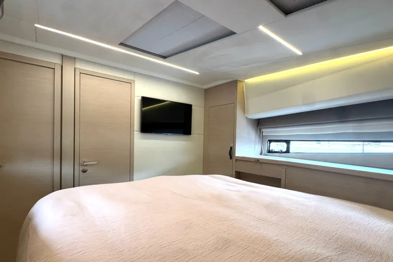 Serenity Yacht Photos Pics Luxurious bedroom interior of 2023 Prestige 460S yacht with modern design and ambient lighting.