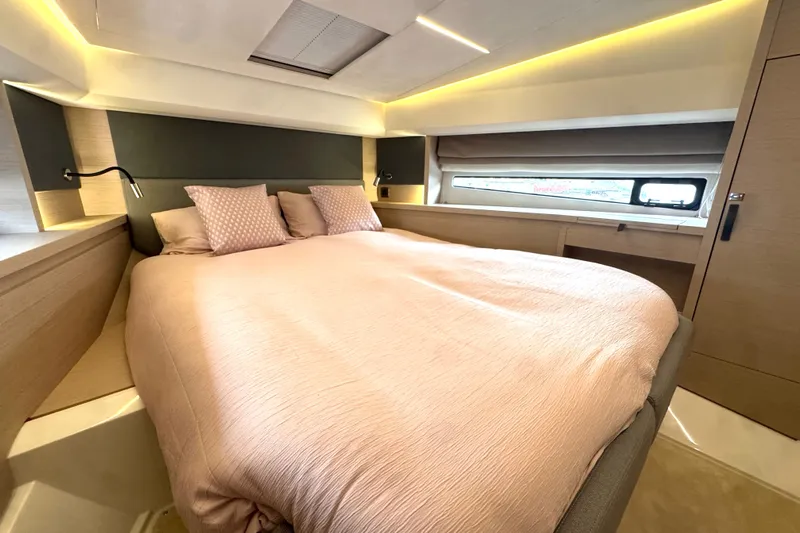 Serenity Yacht Photos Pics Luxurious bedroom interior of 2023 Prestige 460S yacht with modern design and ambient lighting.