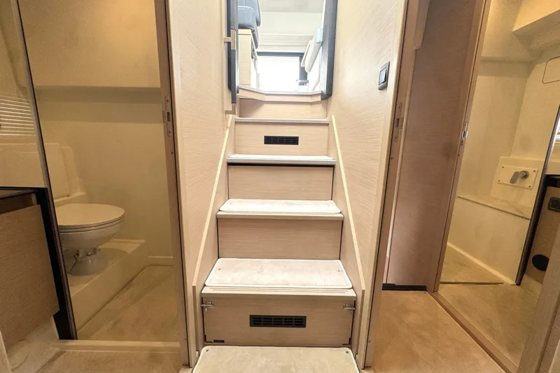 Serenity Yacht Photos Pics Interior of 2023 Prestige 460S yacht with stairs and bathroom.