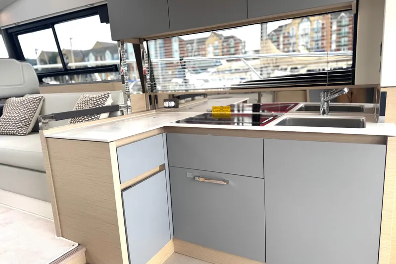 Serenity Yacht Photos Pics Modern kitchen interior of 2023 Prestige 460S yacht with sleek design and amenities.