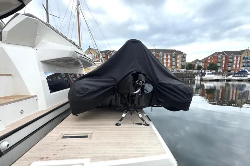 Serenity Yacht Photos Pics 2023 Prestige 460S yacht docked, covered equipment on deck, marina background.