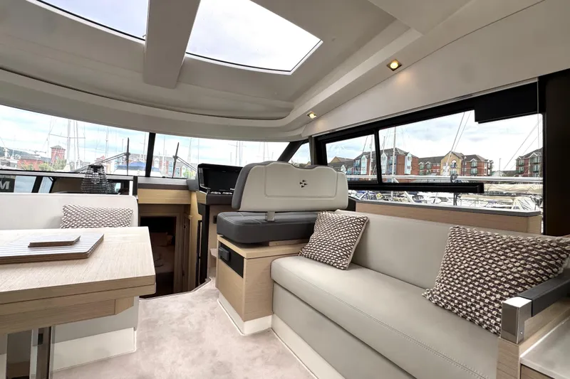 Serenity Yacht Photos Pics Luxurious interior of 2023 Prestige 460S yacht with modern seating and panoramic windows.