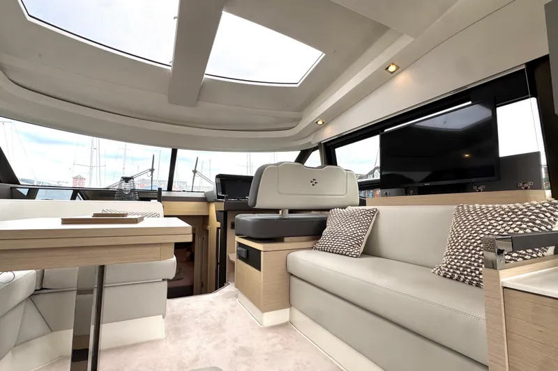 Serenity Yacht Photos Pics Luxurious interior of 2023 Prestige 460S yacht with modern seating and large windows.
