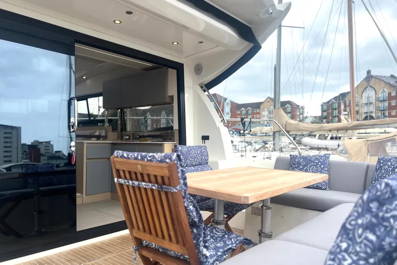 Serenity Yacht Photos Pics Luxurious 2023 Prestige 460S yacht with elegant outdoor seating and modern interior design.