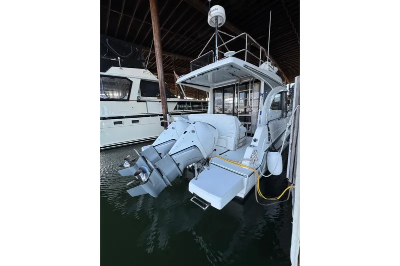  Yacht Photos Pics 2025 Beneteau Antares 11 Fly docked, showcasing dual outboard motors.