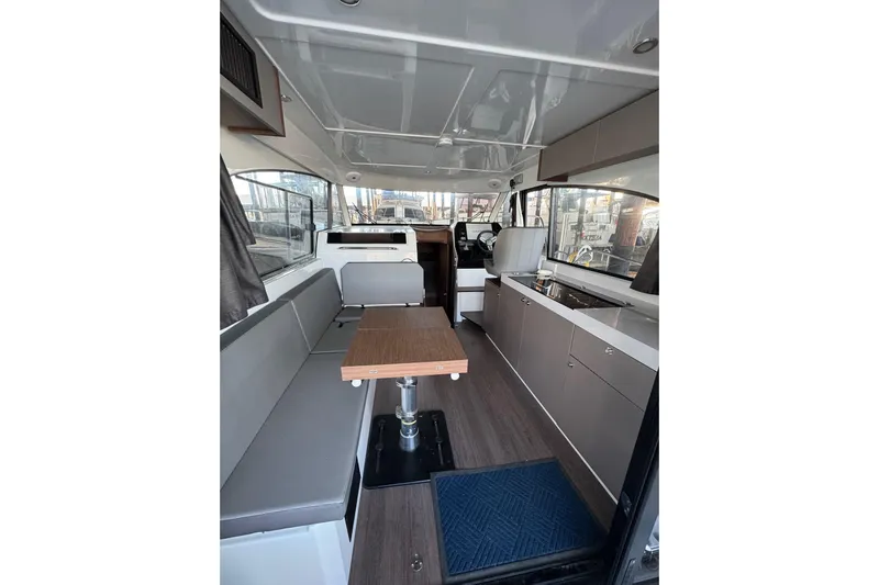  Yacht Photos Pics Interior of 2025 Beneteau Antares 11 Fly, featuring modern seating and kitchen area.