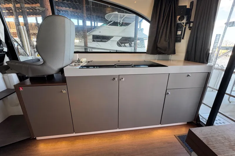  Yacht Photos Pics Interior of 2025 Beneteau Antares 11 Fly, featuring modern cabinetry and seating.