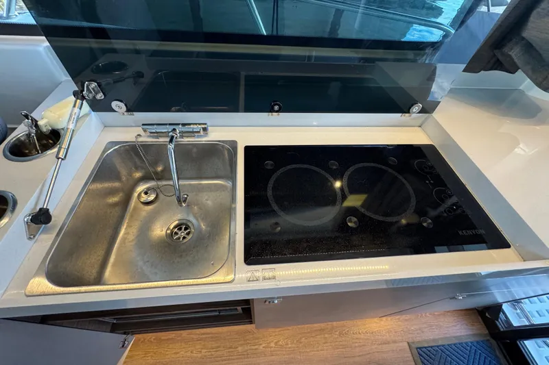  Yacht Photos Pics Modern kitchen in 2025 Beneteau Antares 11 Fly with sink and electric cooktop.