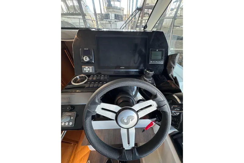  Yacht Photos Pics Helm of 2025 Beneteau Antares 11 Fly with modern navigation controls and steering wheel.