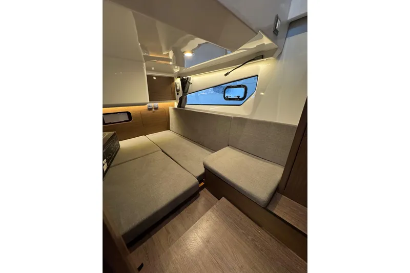  Yacht Photos Pics Interior of 2025 Beneteau Antares 11 Fly, featuring modern seating and window view.