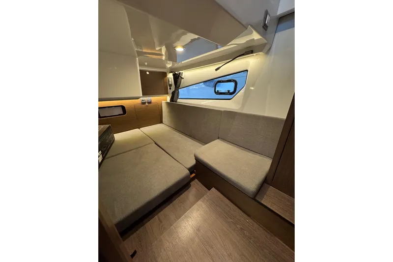  Yacht Photos Pics Interior of 2025 Beneteau Antares 11 Fly, featuring cozy seating and modern design.