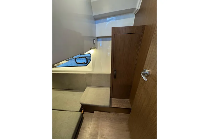  Yacht Photos Pics Interior of 2025 Beneteau Antares 11 Fly, featuring wooden cabinetry and seating.