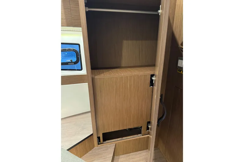  Yacht Photos Pics Interior storage cabinet on 2025 Beneteau Antares 11 Fly yacht, featuring wooden finish.